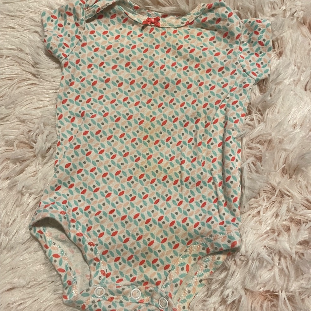 Baby girls white with blue/pink designs onesies.